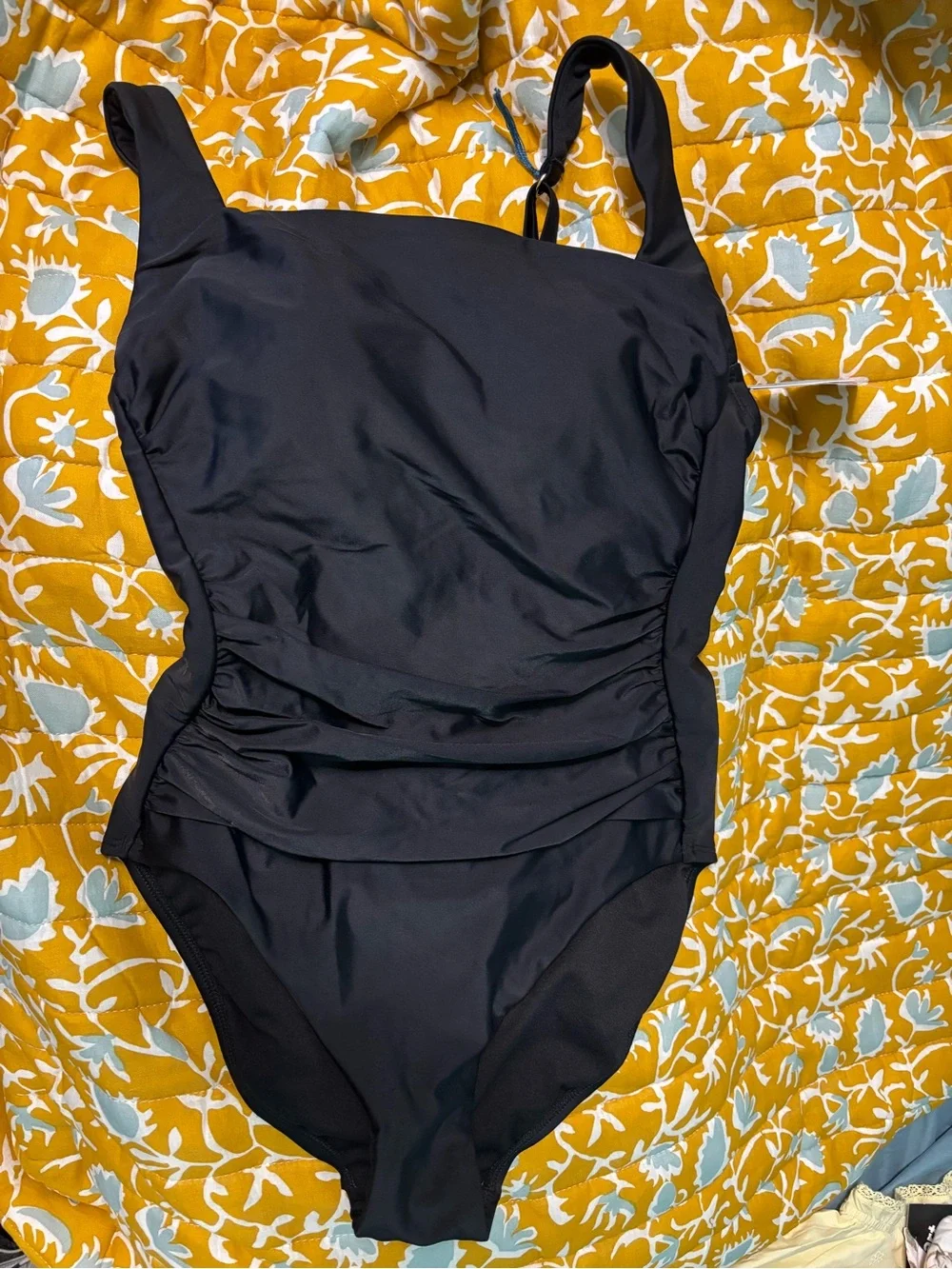 Black swimsuit with gold accessories